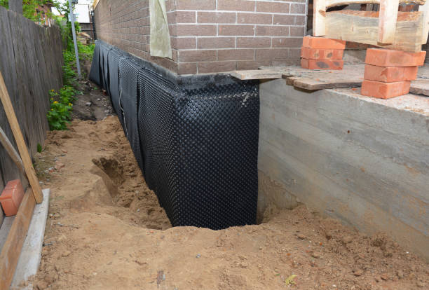 Happy homeowners after waterproofing job in Iron City